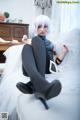 A woman sitting on top of a white couch.