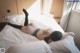 A woman laying on top of a bed in a bedroom.