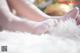 A close up of a woman's feet in white socks.