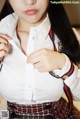 A woman wearing a white shirt and a red and blue tie.