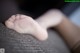 A close up of a baby's foot on a couch.