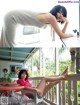 A woman sitting at a table with her legs up on a balcony.