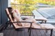 A woman laying on a lounge chair on a deck.