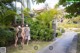 A couple of women standing next to each other in a garden.