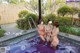 A group of women in bikinis standing in a pool of water.