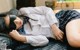 A woman laying on a couch with a blindfold on her face.