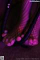 A close up of a woman's feet in fishnet stockings.