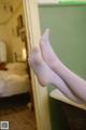 A pair of white stockings sitting on top of a bathtub.